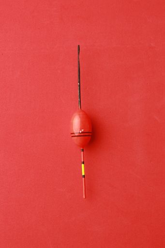 An overhead shot of a colorful popping cork on red background