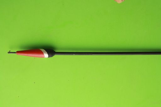 A closeup shot of the fishing lure isolated on a green background