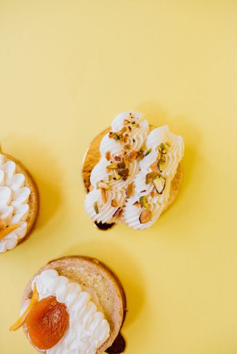 A high angle shot of different kinds of pastries on yellow surface