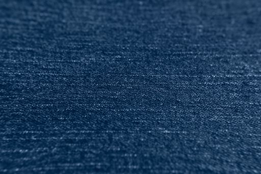 Denim texture. Blue jeans background, with selective focus. The focus is on the center of the image.