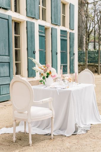 A vertical shot of a wedding table decorated with flowers outside