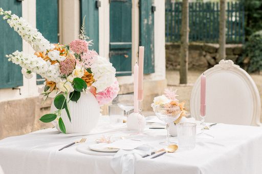 A wedding table decorated with flowers outside