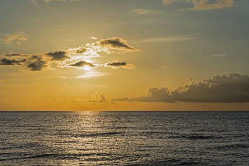 A scenic shot of a sunset over the calm sea