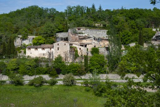 A beautiful scenery of run-down farmhouses cling to a hill in Provence