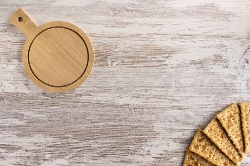 A high angle shot of a wooden plate and some biscuits on a wooden surface