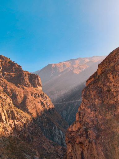 Amazing view between two mountains with a flash of sunlight coming from the right side.