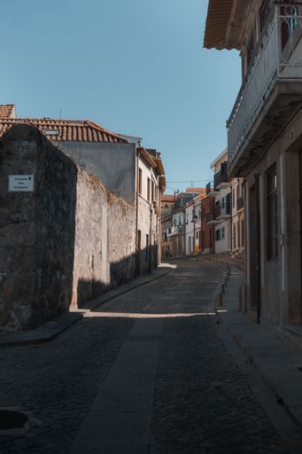 A vertical shot of narrow street between old medieval buildings in Vila do Conde, Porto, Portugal