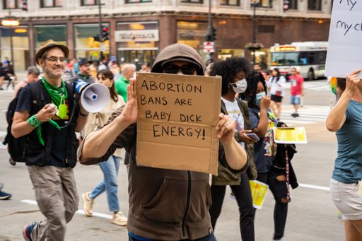 Protesters holding signs My Body My Choice, Ban bombs not Bodies, Abortion rights, People with placards supporting abortion rights at protest in USA