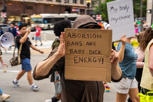 Protesters holding signs My Body My Choice, Ban bombs not Bodies, Abortion rights, People with placards supporting abortion rights at protest in USA