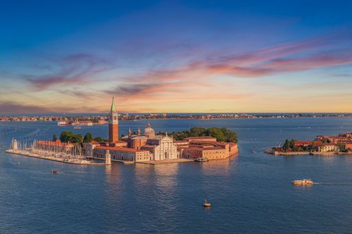 The Church of San Giorgio Maggiore surrounded by canals during the sunset in Venice, Italy