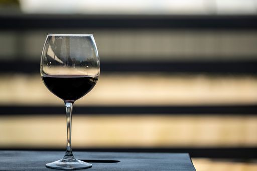 A glass with red wine on a balcony table