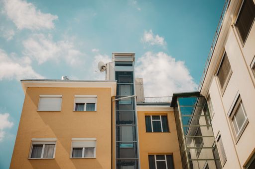 A low angle shot of a yellow residential building in Vienna, Austria