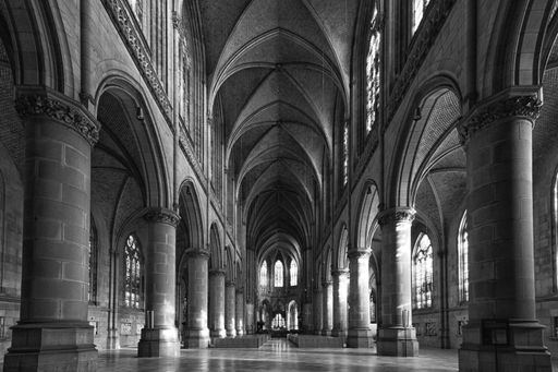 A grayscale shot of the impressive interior of a historic church in Austria