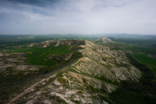 A top view of breathtaking mountains in a green area
