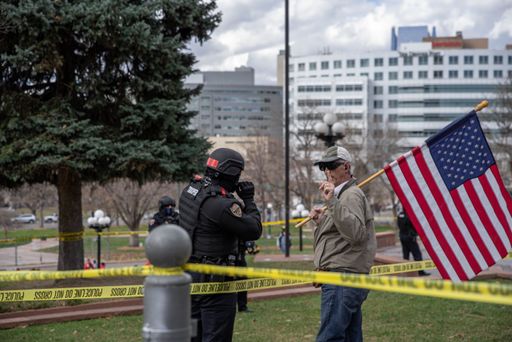 A protestor with a flag talking to a policeman in Denver, USA