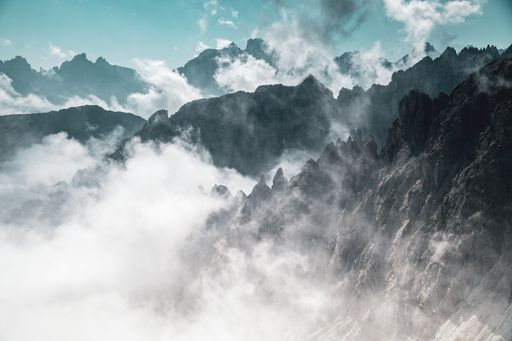 An aerial shot of mountains in fog