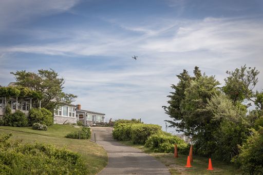 A drone for aerial photography and cinematography flying over homes