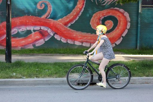 A young woman riding a bike in Vancouver, British Columbia, Canada