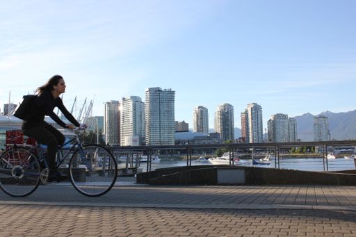 A young female riding a bicycle in downtown Vancouver, Canada