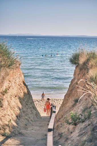 A vertical shot of people walking in Bilotinjak beach, Croatia