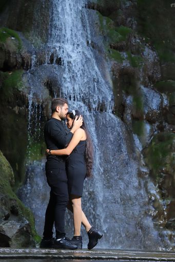 Couple photo shoot in nature. look at the waterfall behind