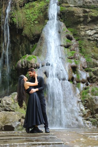 Couple photo shoot in nature. look at the waterfall behind