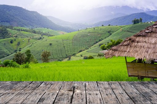 A wooden dock against green rural hills and mountains
