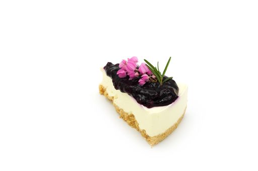 The close-up view of a piece of berry cheesecake isolated on the white background