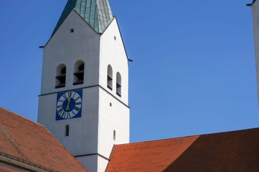 The architectural detail of the tower of a church, St Maria and St Korbinian in Freising showing tower, clock and roof
