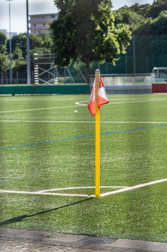 A vertical shot of a corner flag on a football field