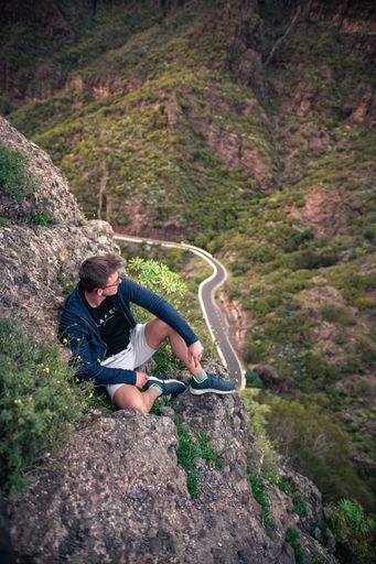 A Caucasian male hiker on top of a mountain during sunset in Masca, Tenerife, Spain