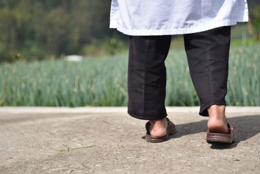 A shallow focus shot of a person's legs from behind during walking