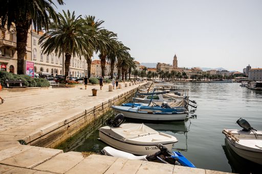 An aerial view of boats parked on river surrounded by buildings in Split