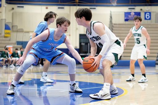 A young white basketball player dribbling the ball