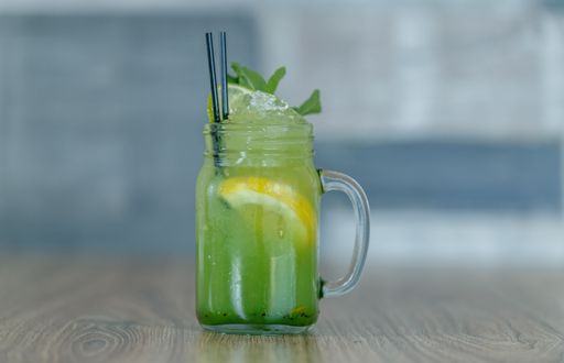 A fresh lemonade with lemon and mint in a jar