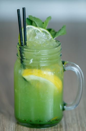 A fresh lemonade with lemon and mint in a jar