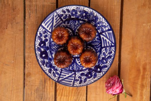 A high angle shot of some homemade chocolate cookies on a plate on a wooden surface