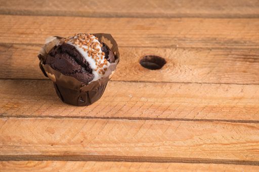 A high angle shot of homemade chocolate cupcakes on a wooden surface
