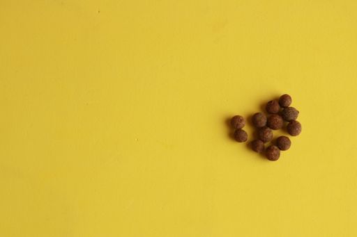 A high angle shot of some chocolate cereals isolated on a yellow surface