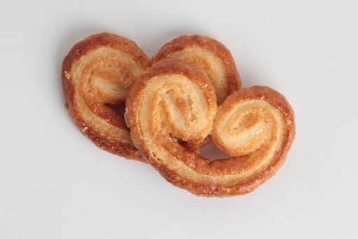 A high angle shot of two pieces of pretzel-shaped bread isolated on a white surface