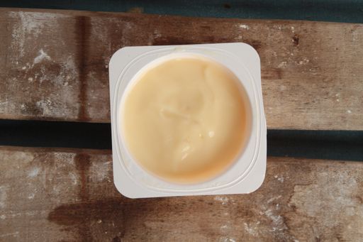 A top view of a banana yogurt on the wooden table