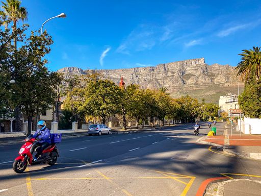 A delivery driver driving in Cape Town with Table Mountain in the background during coronavirus lockdown level 4