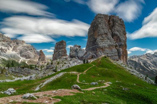 A scenic shot of rocky Dolomitic Mountains in Italy with a cloudscape in the background