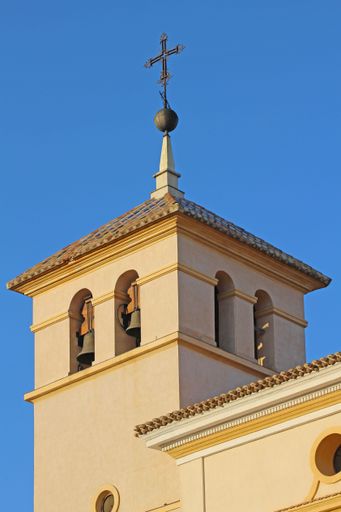 The vertical view of Parroquia de San Pedro Apostol En Calasparra building under the blue sky