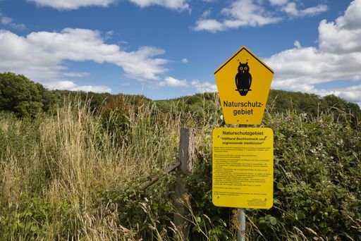 Munkbrarup, Germany, July 8 2020, shot of a yellow sign with an owl an the German word Naturschutzgebiet, translation: nature reserve