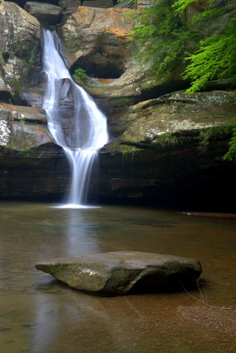 A vertical shot of a small waterfall in Hocking Hills, Ohio