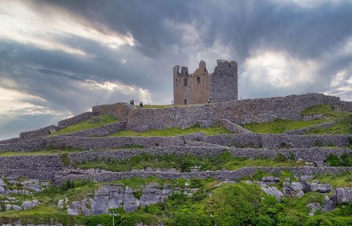 The O' Brien castle on the Aran Island against a cloudy sky in Ireland