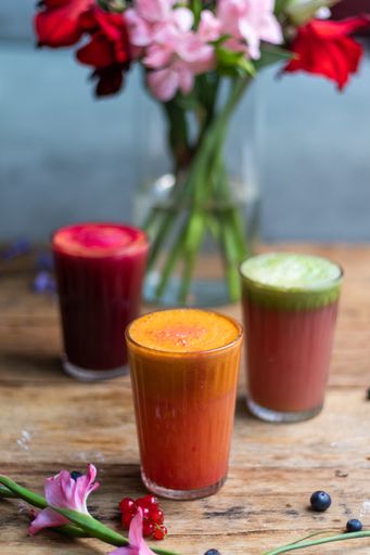 A vertical shot of fresh healthy squeezed fruit juices