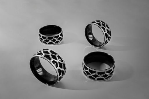 A closeup shot of four silver rings isolated on white background