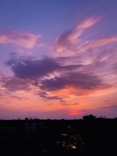 A scenic view of the sunset with purple and pink sky
